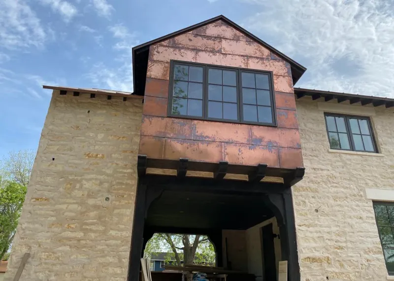 Copper metal panel facade on a stone building for Metal Roof Coating in Goddard